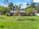 Charming single-story home boasts a large front yard, mature landscaping, and freshly painted facade at 504 Prado Pl, Lakeland, FL 33803