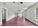 Bright living room features wood-look flooring, neutral walls, ceiling fan and ample natural light at 504 Prado Pl, Lakeland, FL 33803