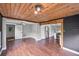 Open-concept living room with wood floors, view to kitchen, and wood ceiling beams at 504 Prado Pl, Lakeland, FL 33803
