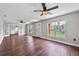Bright living room features wood-look flooring, neutral walls, ceiling fans, and ample natural light at 504 Prado Pl, Lakeland, FL 33803