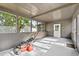 Covered and screened in porch featuring new paint and concrete floor; door leads to backyard at 504 Prado Pl, Lakeland, FL 33803