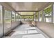 Covered and screened in porch featuring new paint and concrete floor; great for enjoying the outdoors at 504 Prado Pl, Lakeland, FL 33803