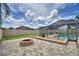 A large backyard features a fire pit and enclosed pool area, perfect for outdoor activities and relaxation at 5313 Nichols W Dr, Lakeland, FL 33812