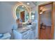 Bathroom with a granite-topped vanity and modern round light-up mirror at 5313 Nichols W Dr, Lakeland, FL 33812