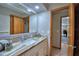 Bright bathroom featuring granite countertops, neutral walls, and an open doorway to an adjacent room at 5313 Nichols W Dr, Lakeland, FL 33812