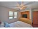 Bedroom featuring a bed, closet, two large windows, and a television set on top of a dresser at 5313 Nichols W Dr, Lakeland, FL 33812