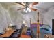 Cozy bedroom featuring a ceiling fan, desk area, and comfortable bed at 5313 Nichols W Dr, Lakeland, FL 33812