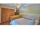 Bedroom with bed and dark wood sliding closet doors, illuminated by a ceiling fan and recessed lighting at 5313 Nichols W Dr, Lakeland, FL 33812