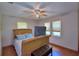 Bedroom with a fan and light fixture on the ceiling and a bed with a padded headboard and footboard at 5313 Nichols W Dr, Lakeland, FL 33812