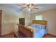 Bedroom featuring a ceiling fan, a bed with a padded headboard and footboard, and vinyl wood-look flooring at 5313 Nichols W Dr, Lakeland, FL 33812