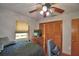 Bedroom with a bed, tv on a dresser, ceiling fan, and a window, complemented by wood-look floors at 5313 Nichols W Dr, Lakeland, FL 33812