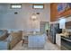 Open kitchen features an island with marble countertop, gray cabinets, stainless steel refrigerator and dining area at 5313 Nichols W Dr, Lakeland, FL 33812