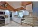 Updated kitchen with granite countertops, stainless steel appliances, and a view of the laundry at 5313 Nichols W Dr, Lakeland, FL 33812