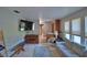 Bright living room with large TV, piano, sofa, nice lighting, and view of entryway at 5313 Nichols W Dr, Lakeland, FL 33812