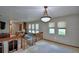 Bright living room featuring neutral walls, plush carpeting, and a charming chandelier at 5313 Nichols W Dr, Lakeland, FL 33812
