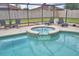 Sparkling pool with a built-in spa, surrounded by a screened enclosure at 5313 Nichols W Dr, Lakeland, FL 33812