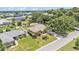 Aerial view of a single Gathering home with a well-manicured front yard and landscaping in a suburban neighborhood at 5548 Woodwind Hills Dr, Lakeland, FL 33812