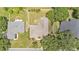 Aerial view of the home showcasing the roof, backyard layout, landscaping, and surrounding neighborhood at 5548 Woodwind Hills Dr, Lakeland, FL 33812