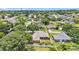 Aerial view of a home with a screened-in porch and fenced yard nestled in a leafy suburban neighborhood at 5548 Woodwind Hills Dr, Lakeland, FL 33812