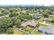 Aerial view of a home with backyard fence and mature trees in a community setting at 5548 Woodwind Hills Dr, Lakeland, FL 33812