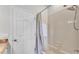 Bathroom features a shower-tub combination, along with granite countertop and a door at 5548 Woodwind Hills Dr, Lakeland, FL 33812