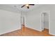 Bedroom with wood floors, doors, ceiling fan, white walls, and white trim at 5548 Woodwind Hills Dr, Lakeland, FL 33812
