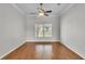 Comfortable bedroom with hardwood flooring and a large window at 5548 Woodwind Hills Dr, Lakeland, FL 33812