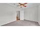 Bedroom with carpet, ceiling fan, white walls, and white trim at 5548 Woodwind Hills Dr, Lakeland, FL 33812