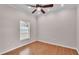 A cozy bedroom with a ceiling fan and natural light from the window at 5548 Woodwind Hills Dr, Lakeland, FL 33812