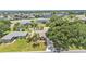 Inviting single-story home features a well-manicured lawn, mature trees, and a paved driveway at 5548 Woodwind Hills Dr, Lakeland, FL 33812