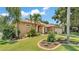 Inviting home exterior with lush landscaping and a well-maintained lawn at 5548 Woodwind Hills Dr, Lakeland, FL 33812