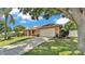 Lovely home exterior with a two-car garage and manicured landscaping at 5548 Woodwind Hills Dr, Lakeland, FL 33812