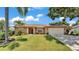Charming single-story home with a well-manicured lawn and mature landscaping at 5548 Woodwind Hills Dr, Lakeland, FL 33812