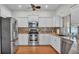 Modern kitchen with stainless steel appliances, granite countertops, and mosaic tile backsplash at 5548 Woodwind Hills Dr, Lakeland, FL 33812