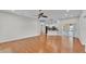 Open-concept living room with hardwood floors and access to kitchen and screened in porch at 5548 Woodwind Hills Dr, Lakeland, FL 33812