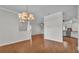 Bright living room with hardwood floors, modern lighting, and open floor plan to kitchen at 5548 Woodwind Hills Dr, Lakeland, FL 33812