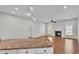 Open-concept living room with hardwood floors, fireplace, and view of the outdoor scenery at 5548 Woodwind Hills Dr, Lakeland, FL 33812