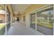 Spacious screened-in porch featuring ceiling fans and sliding glass doors to the living room and backyard at 5548 Woodwind Hills Dr, Lakeland, FL 33812