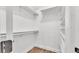 Walk-in closet with shelving and rod for hanging clothes, and wood floor at 5548 Woodwind Hills Dr, Lakeland, FL 33812