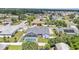 Aerial view featuring the home with screened in pool, surrounded by lush landscaping and mature trees at 5579 Summerland Hills Dr, Lakeland, FL 33812
