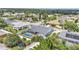 Aerial view showcasing the home with screened pool in fenced yard, set in a lush neighborhood at 5579 Summerland Hills Dr, Lakeland, FL 33812