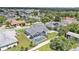Aerial view of a home with a screened pool and white fence in a suburban neighborhood with mature trees at 5579 Summerland Hills Dr, Lakeland, FL 33812
