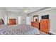 Bedroom featuring wood floors, ceiling fan, a large bed, dual dressers, and natural light at 5579 Summerland Hills Dr, Lakeland, FL 33812