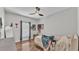Bedroom with wood-look flooring, ceiling fan, natural light, and neutral colored walls at 5579 Summerland Hills Dr, Lakeland, FL 33812