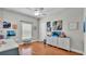 Bright bedroom with wood-look floors, built-in cabinets, a ceiling fan, and natural light at 5579 Summerland Hills Dr, Lakeland, FL 33812