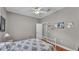 Simple bedroom with wood-look floors, a ceiling fan, natural light, and neutral decor at 5579 Summerland Hills Dr, Lakeland, FL 33812
