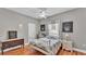 Well-lit bedroom with wood-look floors, ceiling fan, neutral colors, dresser and comfortable bed at 5579 Summerland Hills Dr, Lakeland, FL 33812