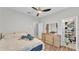 Bedroom with walk-in closet, wood-look floors, a ceiling fan, and large dresser with mirror at 5579 Summerland Hills Dr, Lakeland, FL 33812