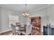 Dining room with wooden table, upholstered chairs, wooden cabinet, and chandelier at 5579 Summerland Hills Dr, Lakeland, FL 33812