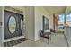 Welcoming front porch with seating area, decorative welcome sign and lovely door with oval window at 5579 Summerland Hills Dr, Lakeland, FL 33812
